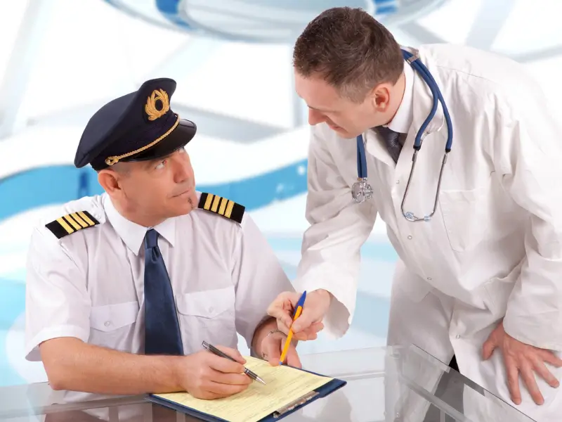 Pilot completing medical declaration paperwork with a doctor, part of the aviation medical certification process